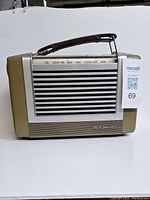 Front view of radio showing RCA Victor logo on front grille and leather carrying handle on top.