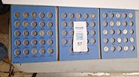 Three blue cardboard coin holders with slots for Roosevelt dimes from 1946 to early 1960s including silver and clad dimes.