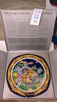 Porcelain decorative plate inside original box with information text on the inside lid
