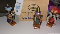 Wide view of three nutcrackers displayed with original wooden Taron Collection box showing brand and edition details.