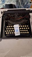Top view of the vintage typewriter showing round keys and ribbon spools.