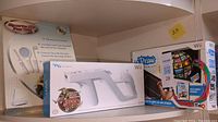 Image showing Wii Sports Kit, Wii Zapper box, and Wii UDraw GameTablet box on shelf