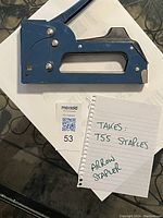 Photo of blue Arrow staple tool with a note indicating it takes T55 staples and the lot number 53.