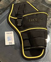 Front view showing drill pouch with compartments and strap with buckle