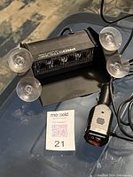 Black LED emergency strobe light labeled 'Prostrobe' with four suction cups and connected to a lighter outlet plug with an inline power switch, placed on a dark surface.