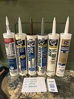 Photo of six tubes of various caulk and sealant in clear, white, gray, and brown colors