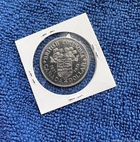 Reverse side of the coin showing British Columbia shield and clover with inscription 'British Columbia Canada Dollar 1871-1971'