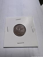 Reverse side of the 1975 Canadian 1 cent coin showing maple leaf design and year 1975.