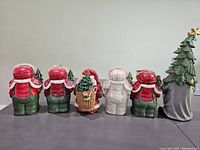 Back view showing the gnome figurines with plaid shirts and pine trees, and the Christmas tree gnome with a star on top.