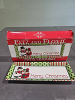 Photo showing the platter with its original box, front view of the platter showing the snowman design and Merry Christmas text with a red, green polka dot and stripe border pattern.