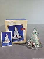 Ornament with original box and booklet showing the product and packaging.