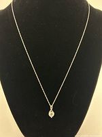 Full view of the 925 sterling silver necklace displayed on a black bust, showing the length and chain style with the heart-shaped pendant at the center.