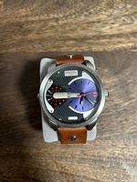 Front view of Diesel watch showing dial details and strap attached to cushion.