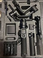 Top-down view of gimbal and accessories arranged in foam insert