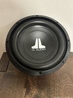 Front view of JL Audio 12-inch subwoofer showing black cone with JL Audio logo