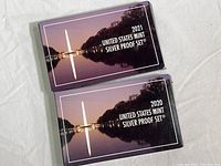 Two sealed outer folders labeled '2021 United States Mint Silver Proof Set' and '2020 United States Mint Silver Proof Set'