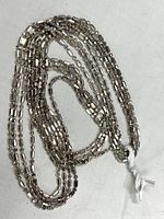 Full view of the sterling silver chain necklace showing its overlapping multi-strand cylindrical link design.