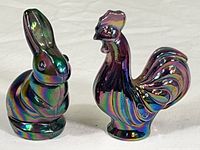 Both Fenton iridescent glass figurines placed side by side showing size and shape