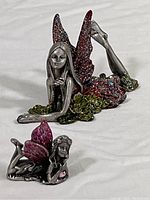 Photo showing both pewter fairy figurines together, highlighting size difference and wing glitter