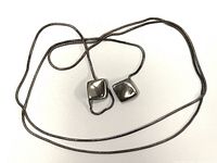 Full view of the sterling silver chain and pendant laid out on white background showing the entire chain and pendant shape