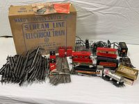Wide view showing original box, track pieces, engine, cars, transformer and accessories