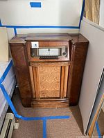 Front view of the antique Silvertone wooden console radio showing overall condition and style