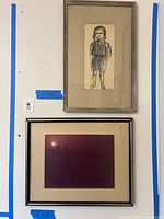 Photo shows two framed artworks hung on a wall, the sketch above with dimensions and the sunset city photo below.