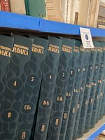 Photo showing Encyclopedia Judaica volumes 4 to 12 with alphabetical lettering on spine.