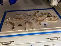 Overview of all jewelry pieces arranged on dresser surface