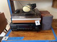 Sherwood stereo system with Philips turntable, two Sony speakers, and Pelter aviation headset on top