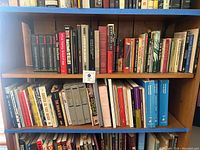 Bookshelves displaying various World War II history and Holocaust studies books, featuring titles such as Behind Enemy Lines and Auschwitz.