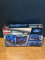 Front and side views of the Lego set box featuring a blue Ford Mustang Dark Horse model car image and product branding.