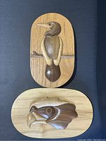 Close up of perched bird plaque showing detail and wood grain.