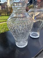 Side view of a crystal vase showing the diamond-cut pattern and its shape
