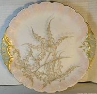 Top view showing the hand-painted floral design in gold and pastels with scalloped edges and gold handles.