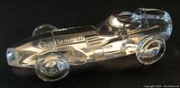 Clear crystal Vanwall 1957/58 Grand Prix race car paperweight viewed from the side showing the detailed crystal sculpting of body and wheels, labeled with 'Vanwall'.
