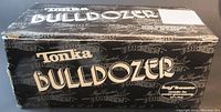 Black box with white Tonka Bulldozer lettering and Hofbauer logo, showing lot packaging.