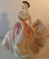 Front view of The Polka Royal Doulton porcelain figurine showing woman in flowing dress pose.