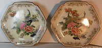 Two hexagon-shaped porcelain plates with colorful hand-decorated pheasant and floral design shown side by side