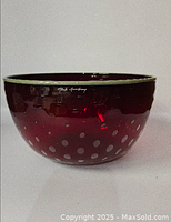 Front view of ruby red glass bowl showing controlled bubble design and signature
