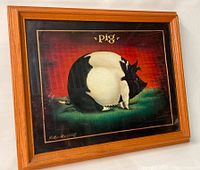 Photo showing the framed print titled "Pig" by D. Lacey Derstine installed in a solid stained wood frame.