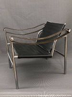 Three-quarter view of chair showing frame and leather sling