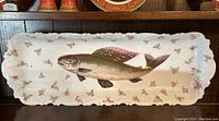 Full view of rectangular porcelain dish with scalloped edges, central fish motif and floral sprays.