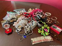 Overhead view of assorted necklaces, bracelets, brooches and earrings on table