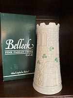 View of the Belleek Castle Vase next to original green box with white lettering.