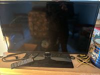 Samsung UN29F4000 television with black bezel and stand, power cord visible.
