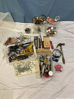 Full lot overview showing all tools and hardware on white sheet background with blue drape behind.