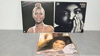 Front covers of 3 of the 5 vinyl LP albums showing female artists portraits: Aretha Franklin, Roberta Flack, and Natalie Cole.