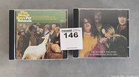 Photo showing two CDs: The Beach Boys Pet Sounds and The Mamas & The Papas 18 of Their Greatest Hits, both in jewel cases.