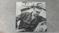 Front cover of Elvis Presley ELVIS: THE HILLBILLY CAT album showing Elvis in a cap and shirt.